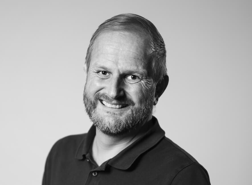 Man with beard smiling, black and white portrait