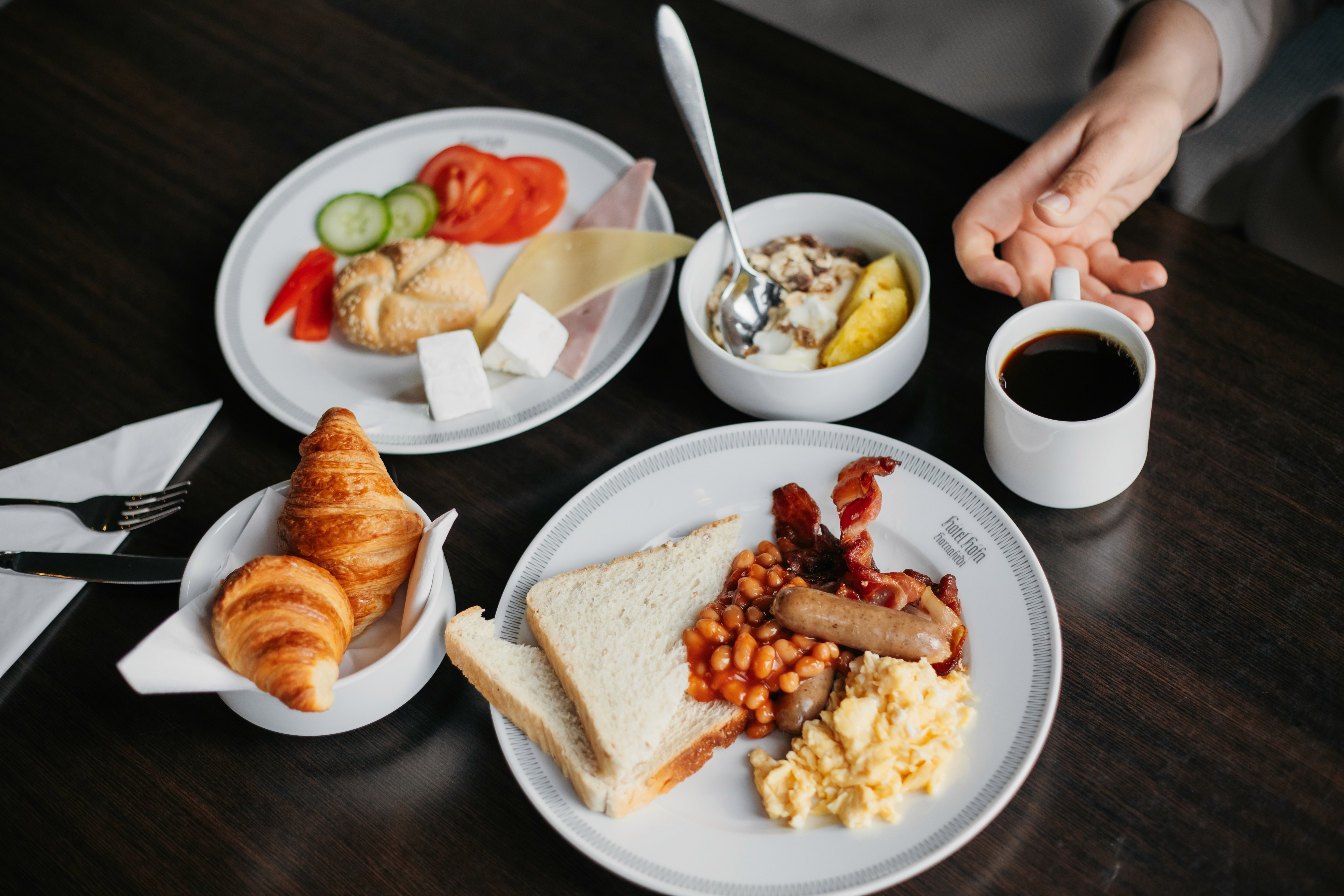 Hótel Höfn breakfast with coffee, croissants, fruit, eggs, bacon, beans, and bread