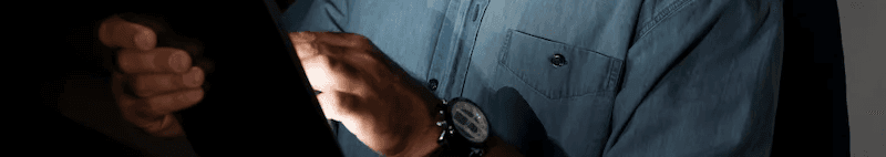 A bearded man wearing glasses and a blue shirt works on a tablet, featured as the testimonial or review hero for the TickedOff case study.