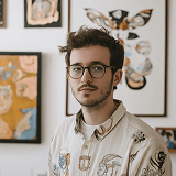 Young man with glasses in modern creative studio workspace
