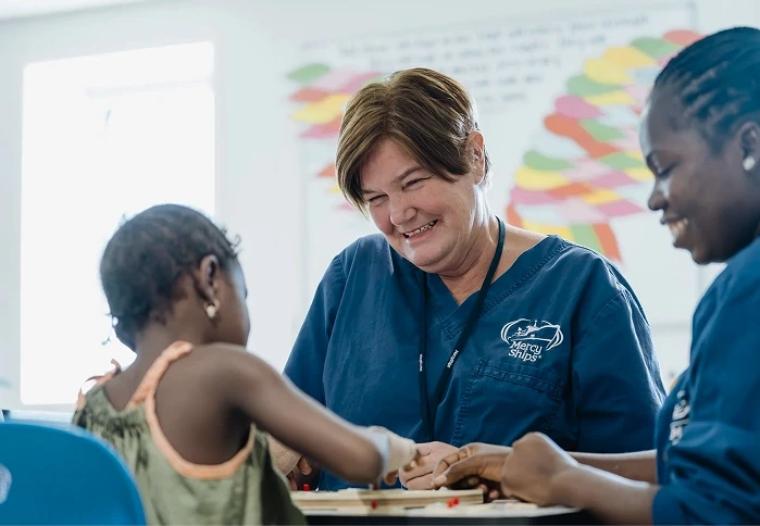 Woman smiling at a young girl