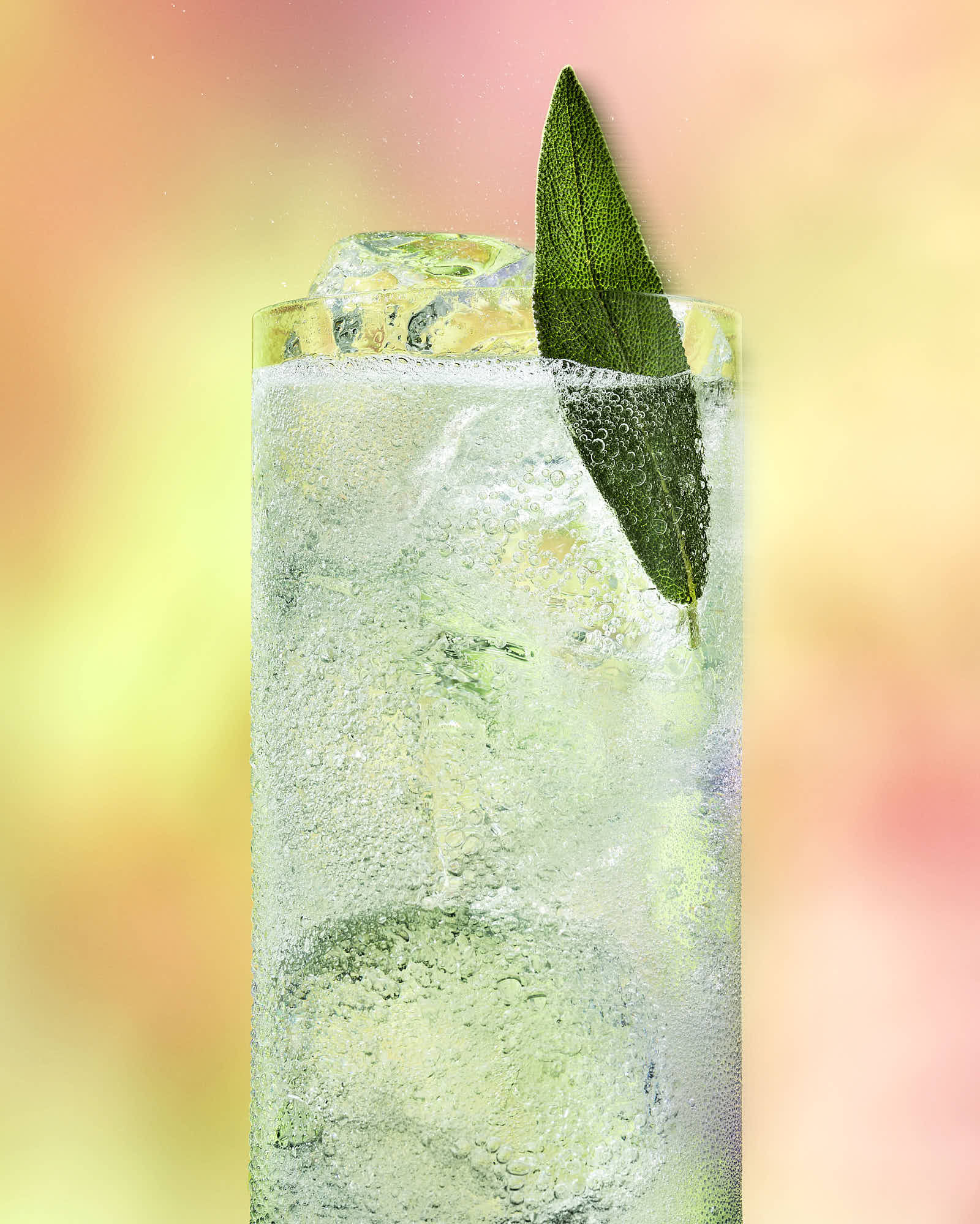 A refreshing drink with mint leaves, served in a tall glass against a vibrant, colorful background.