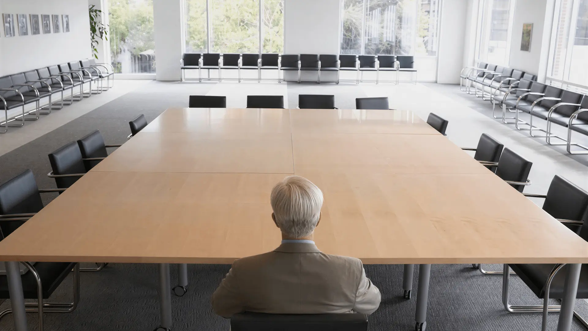 Businessman sitting at empty conference table