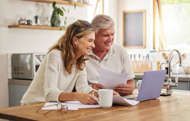 retired couple reviewing finances at kitchen table