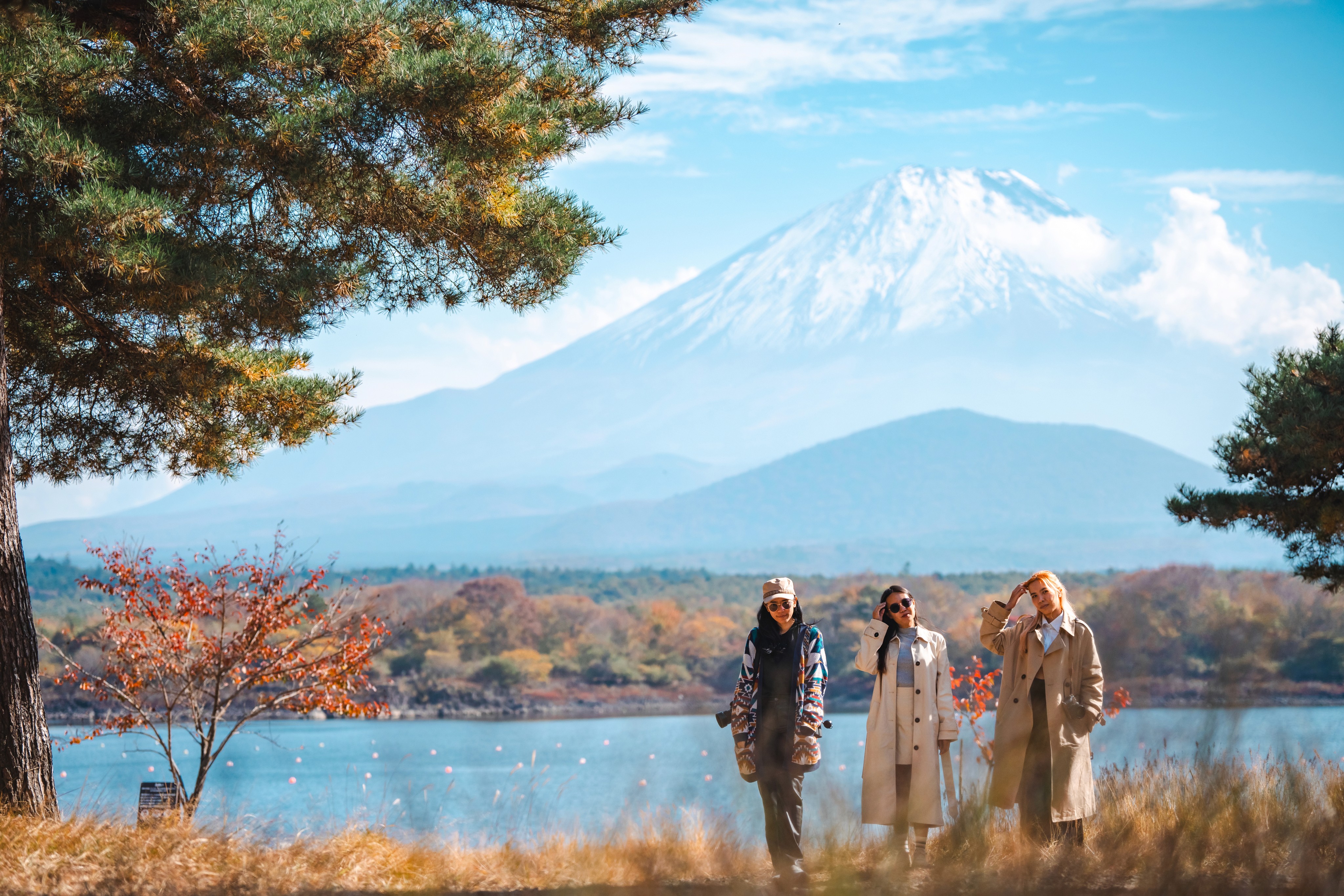 Three travelers in front of Mt. Fuji