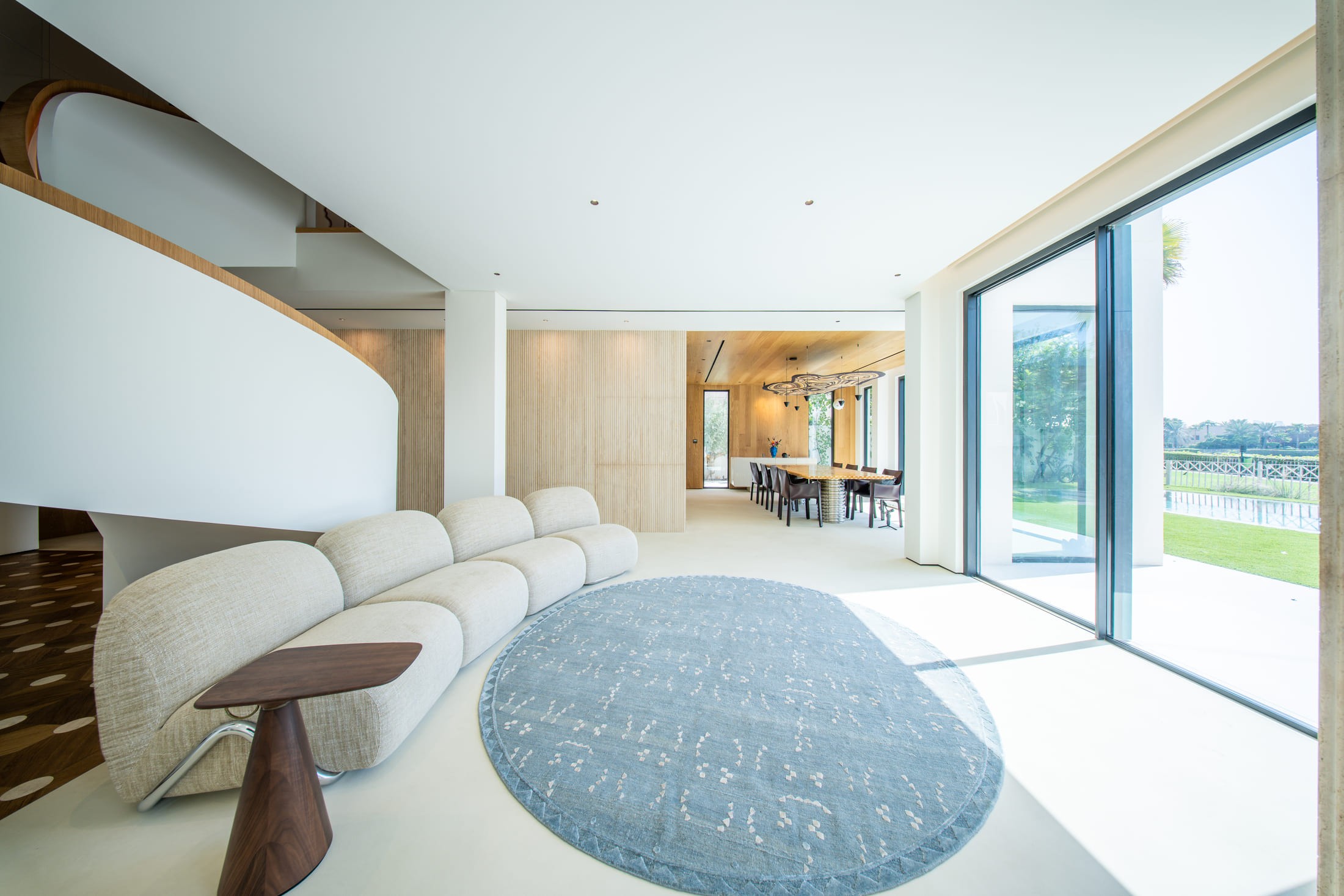 Image of big glass windows and a long couch