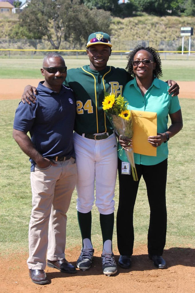 Junior Coleman posing in his baseball uniform for highschool graduation