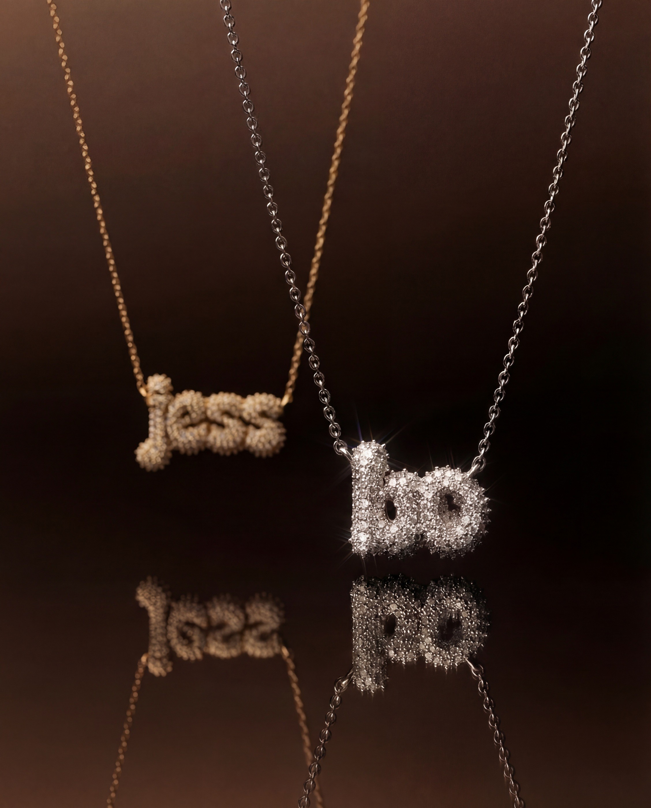 Vedder & Vedder — Jess and Jo pavé necklaces suspended over a reflective surface.