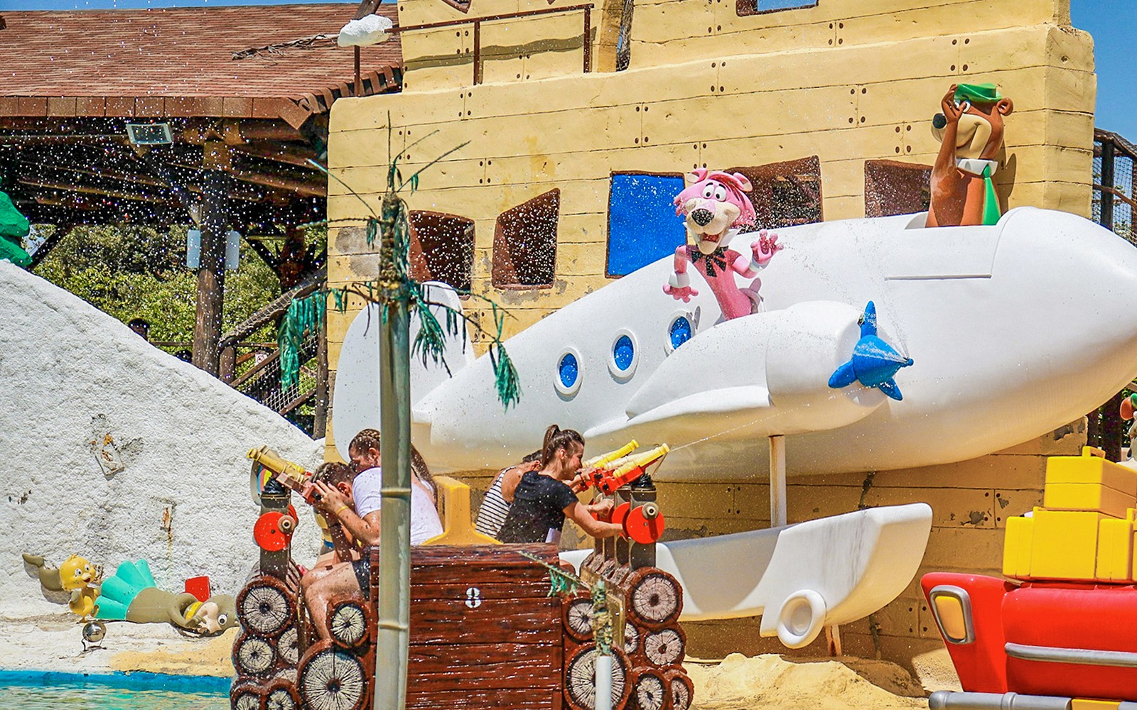 Visitors enjoying water ride with cartoon characters at Parque Warner Madrid.