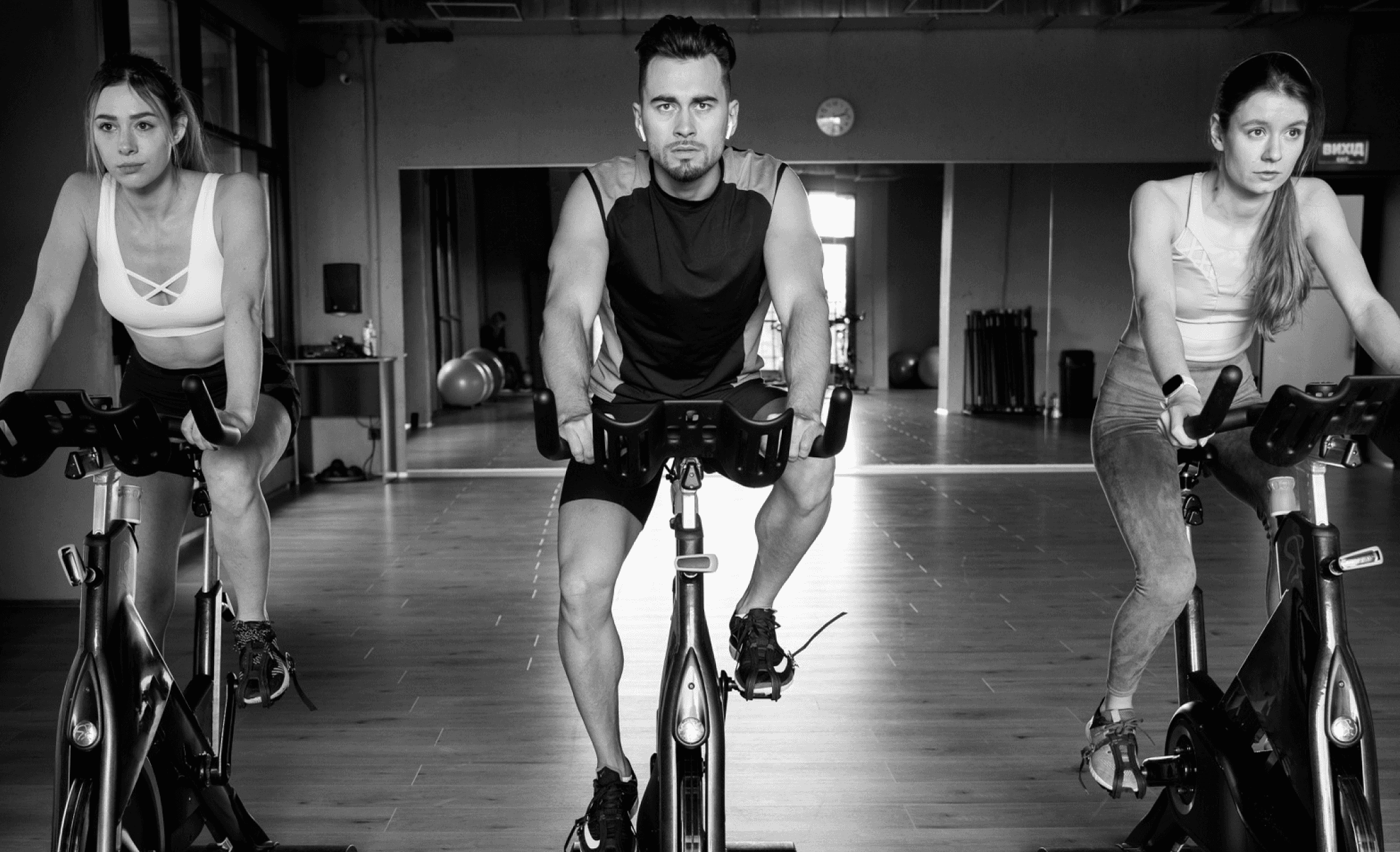 Men doing indoor cycling exercise at gym