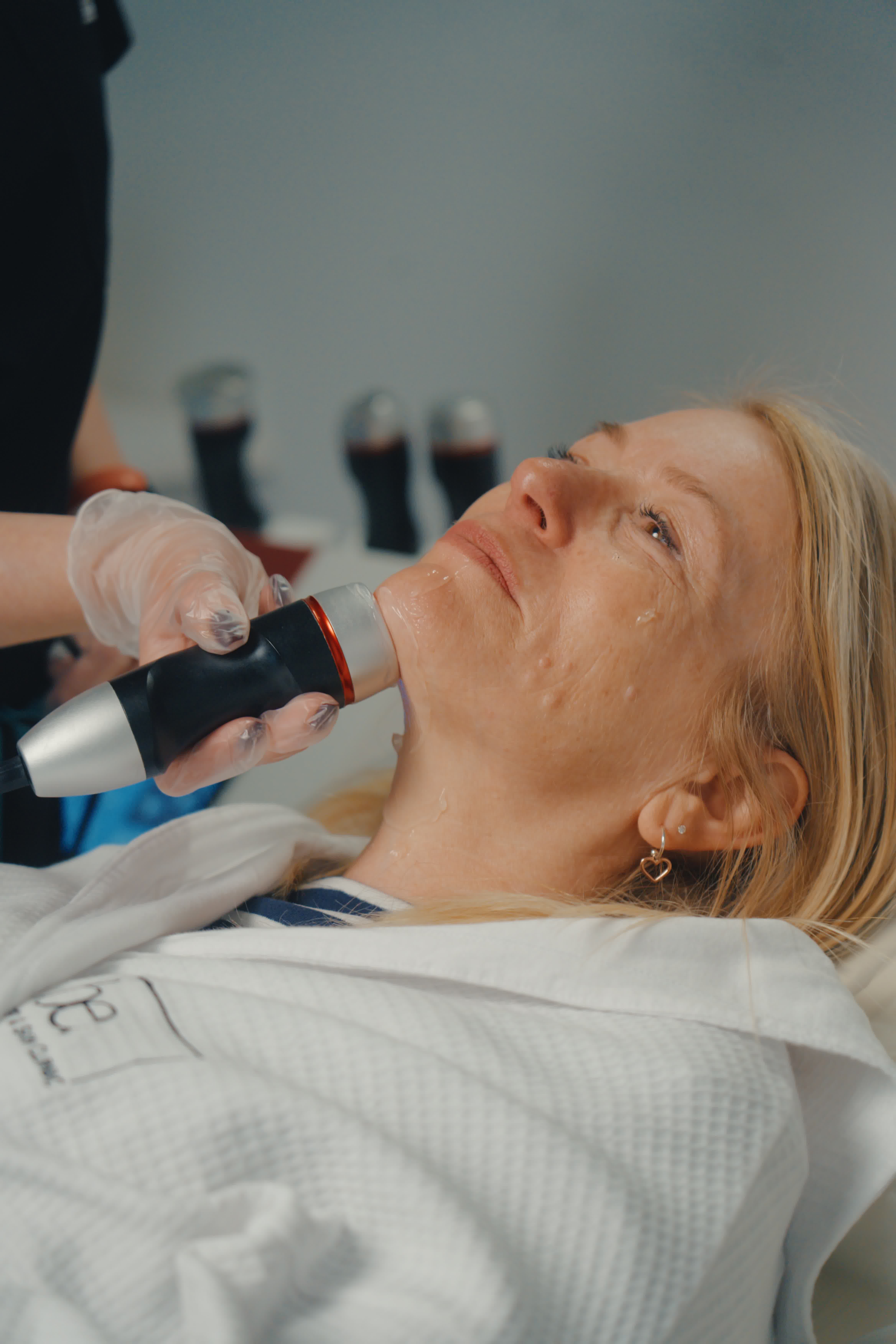Laser treatment on woman's cheek with protective eye shield