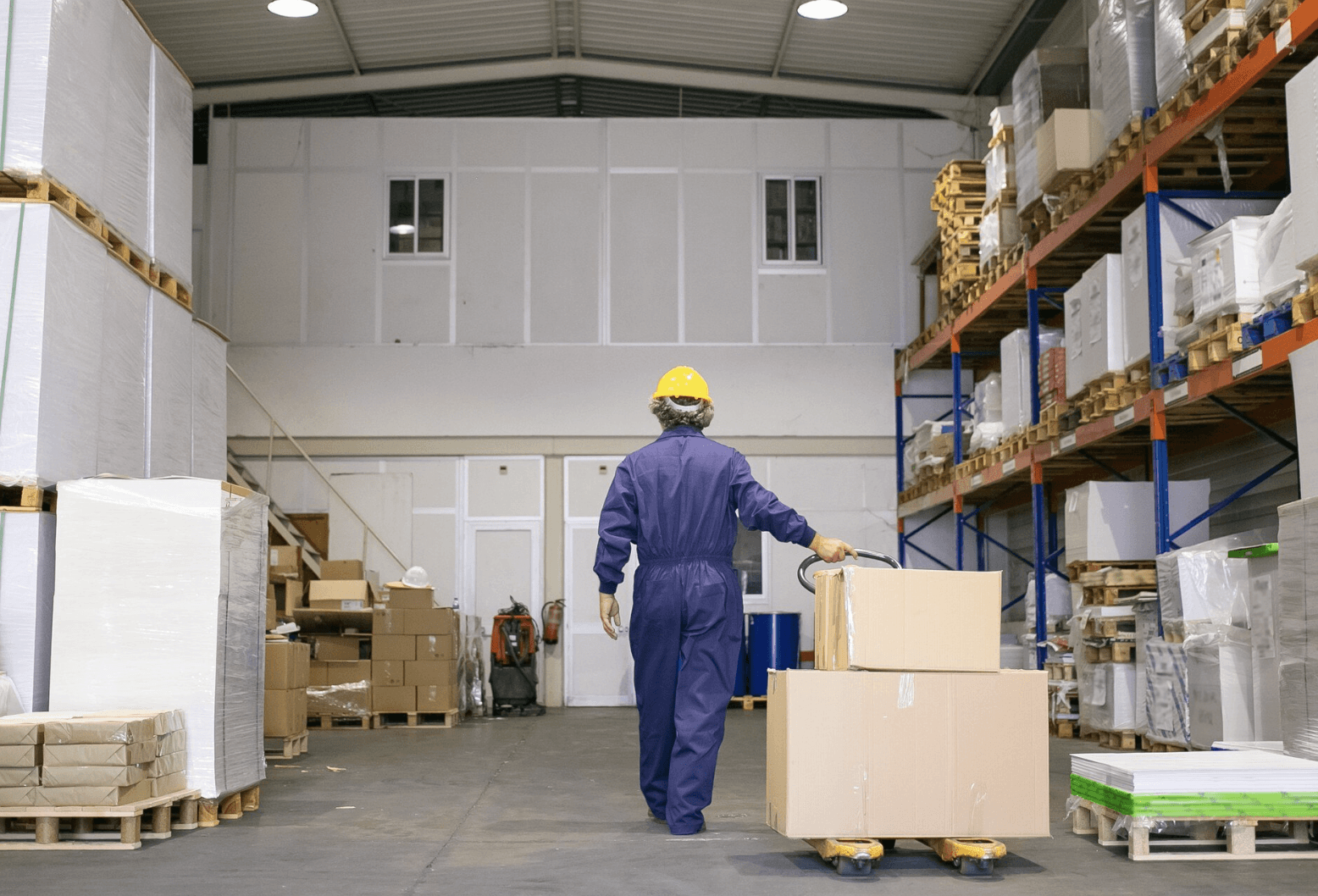 logistics worker moving boxes in warehouse