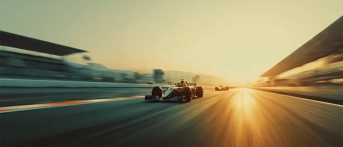 A high-speed Formula 1 car racing into the sunset — representing adrenaline, luxury, and the power of having every extraordinary moment within reach.