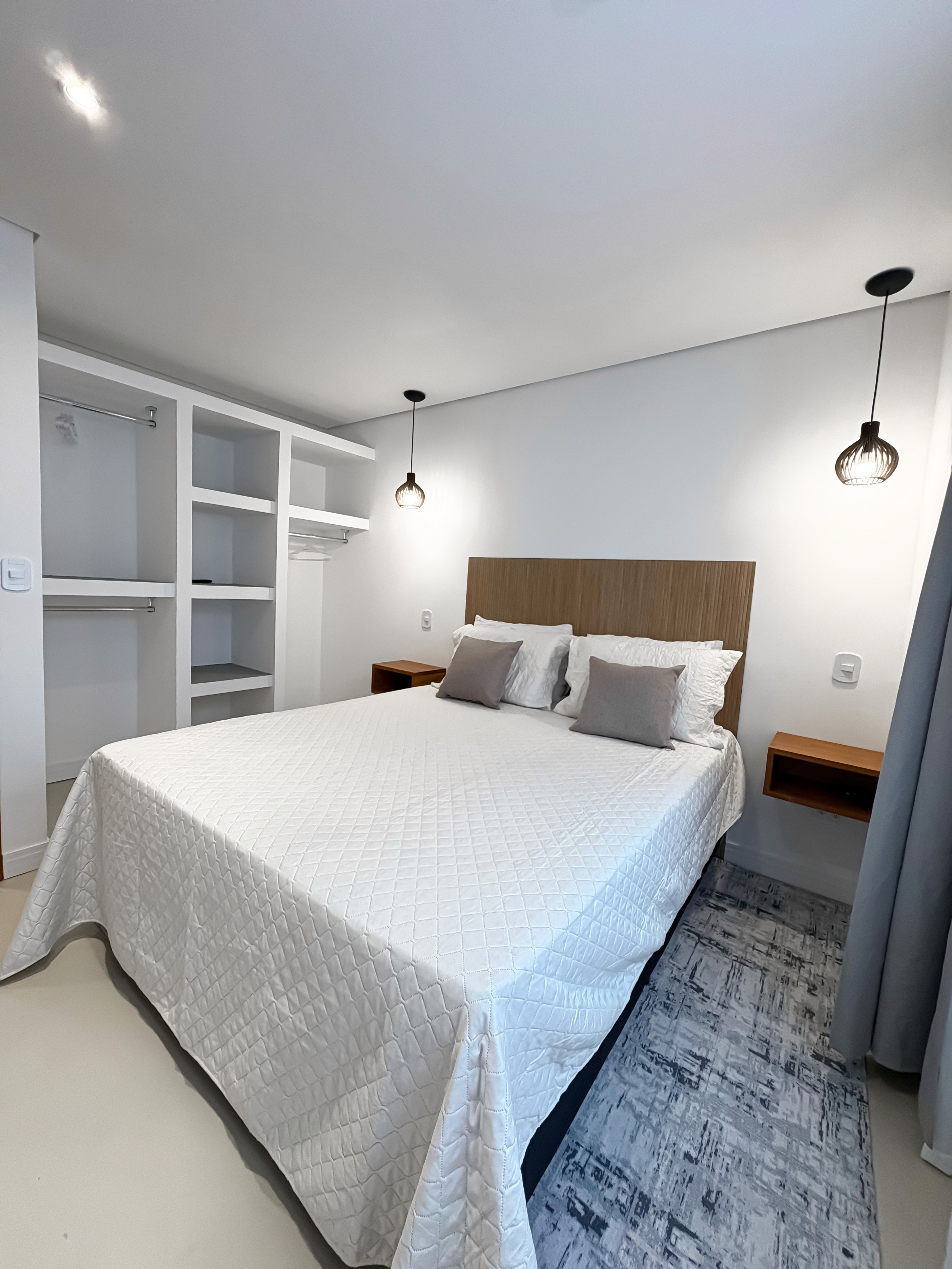indoor-outdoor rain shower with natural stone and wooden slats, light filtering through tropical plants.