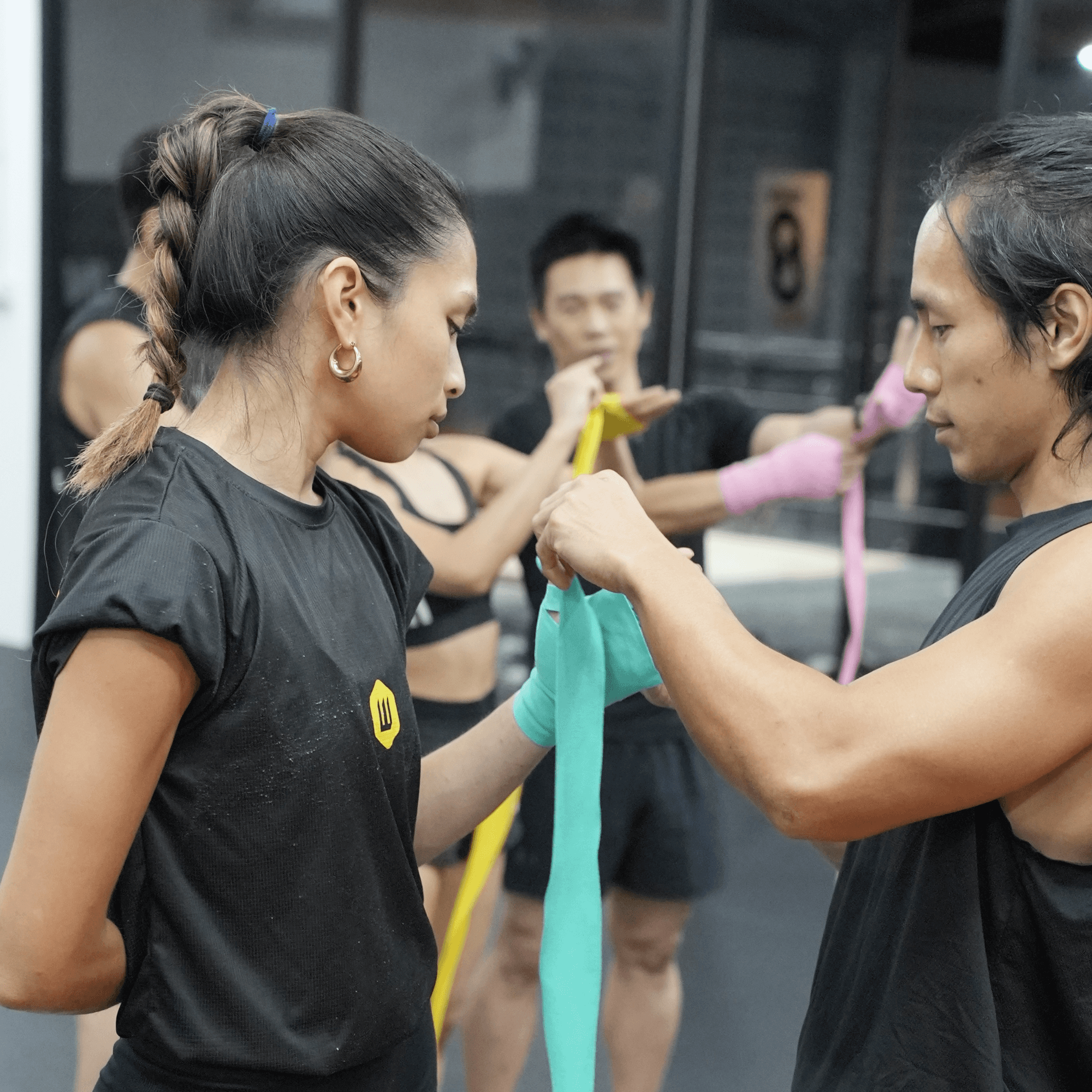 female fighter getting hands wrapped at innov8 mma
