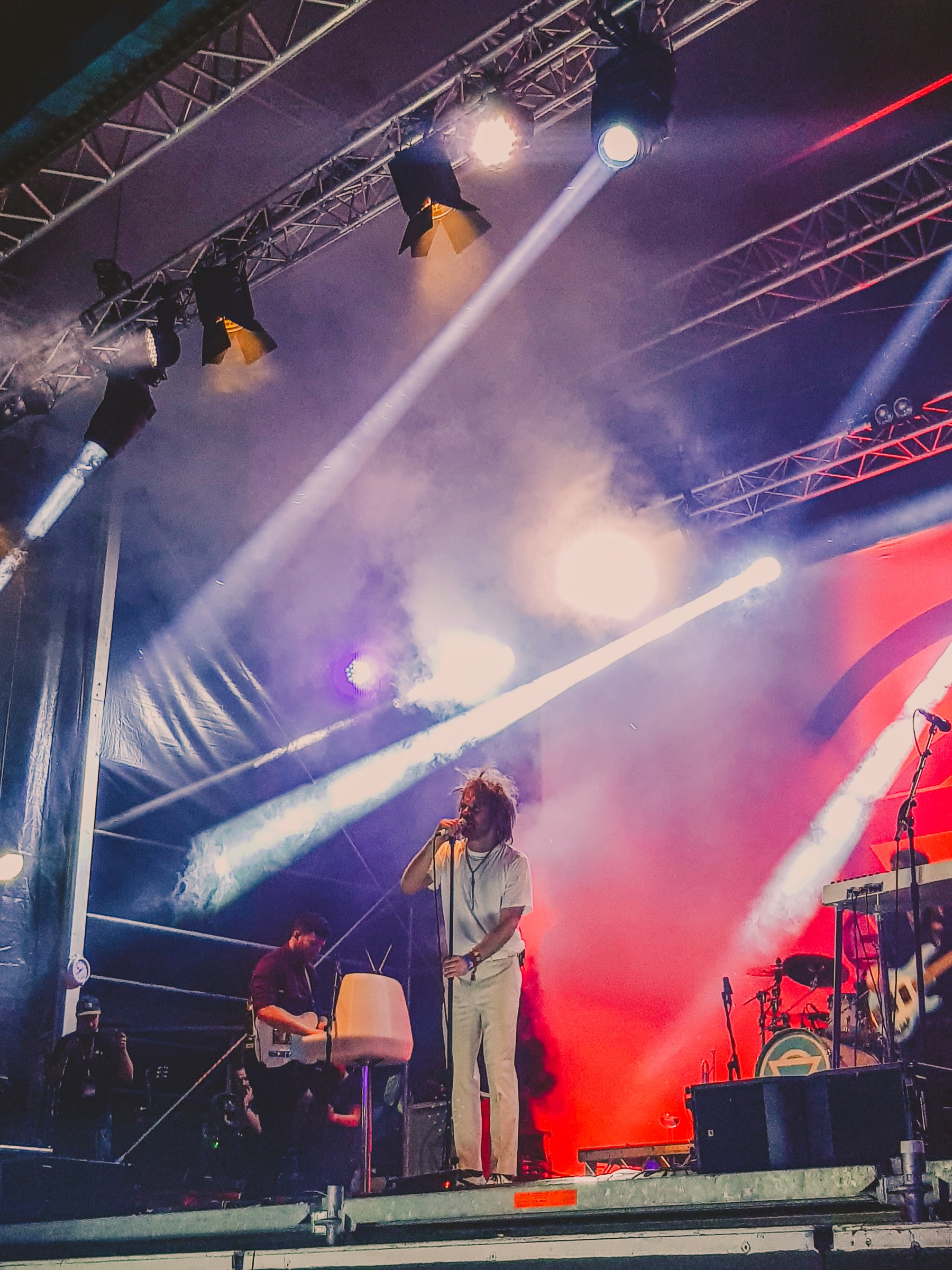 EVENTS · Stage lights cutting through a live performance.