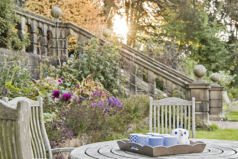 Hartingtons Heritage Tours hotel, Darley House, garden with wooden chairs and table