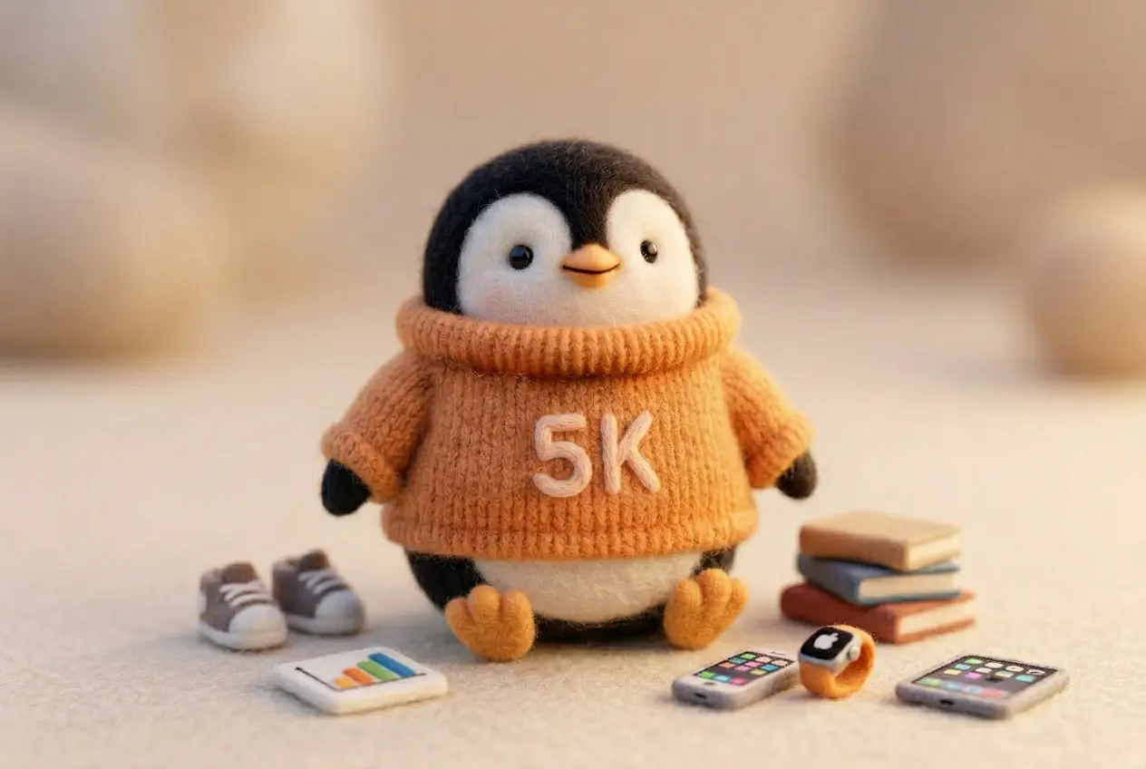 A wool felt penguin in an orange sweater standing confidently among scattered tiny gadgets and charts, ignoring the clutter