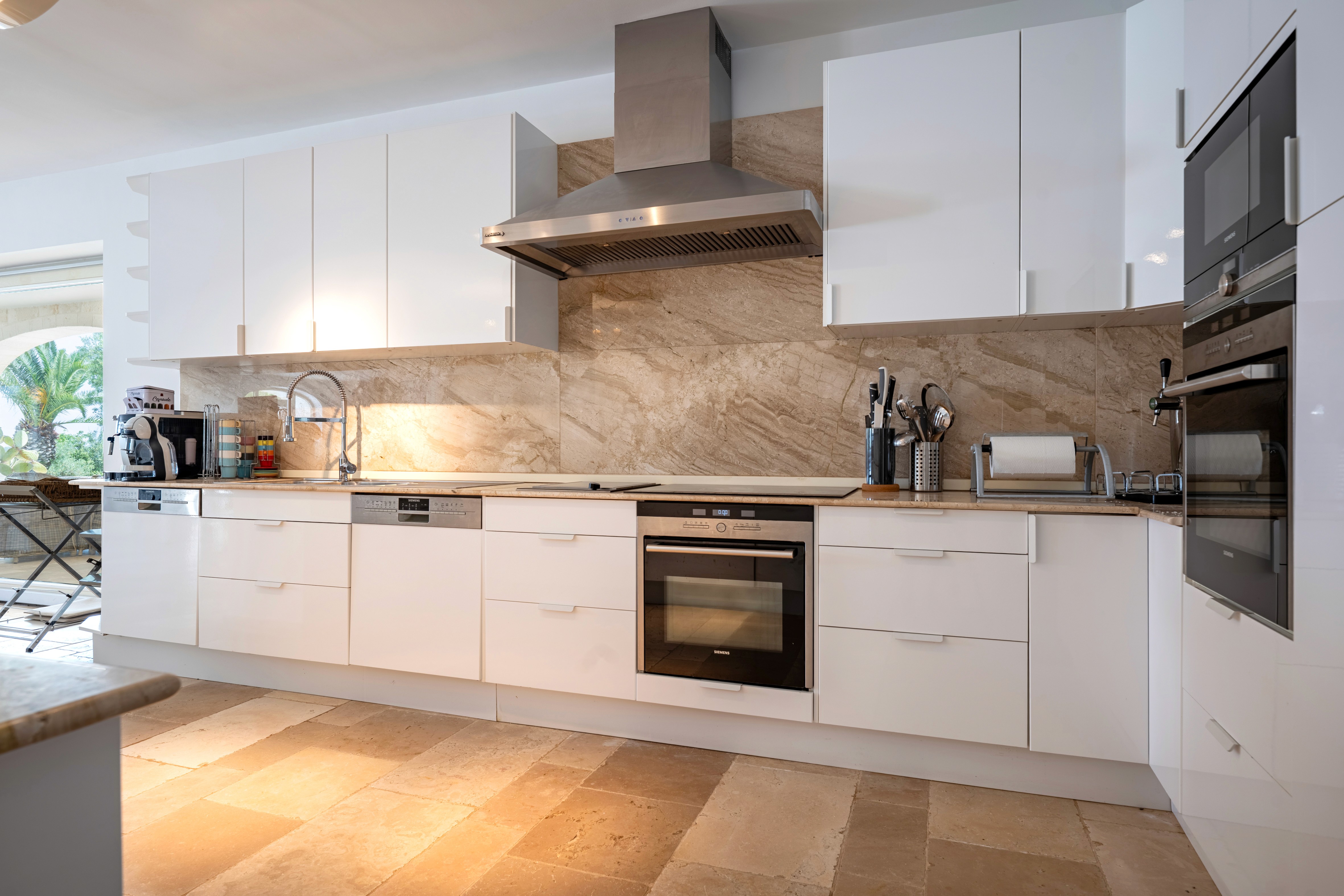 Dining area with red chairs and a view of the living room