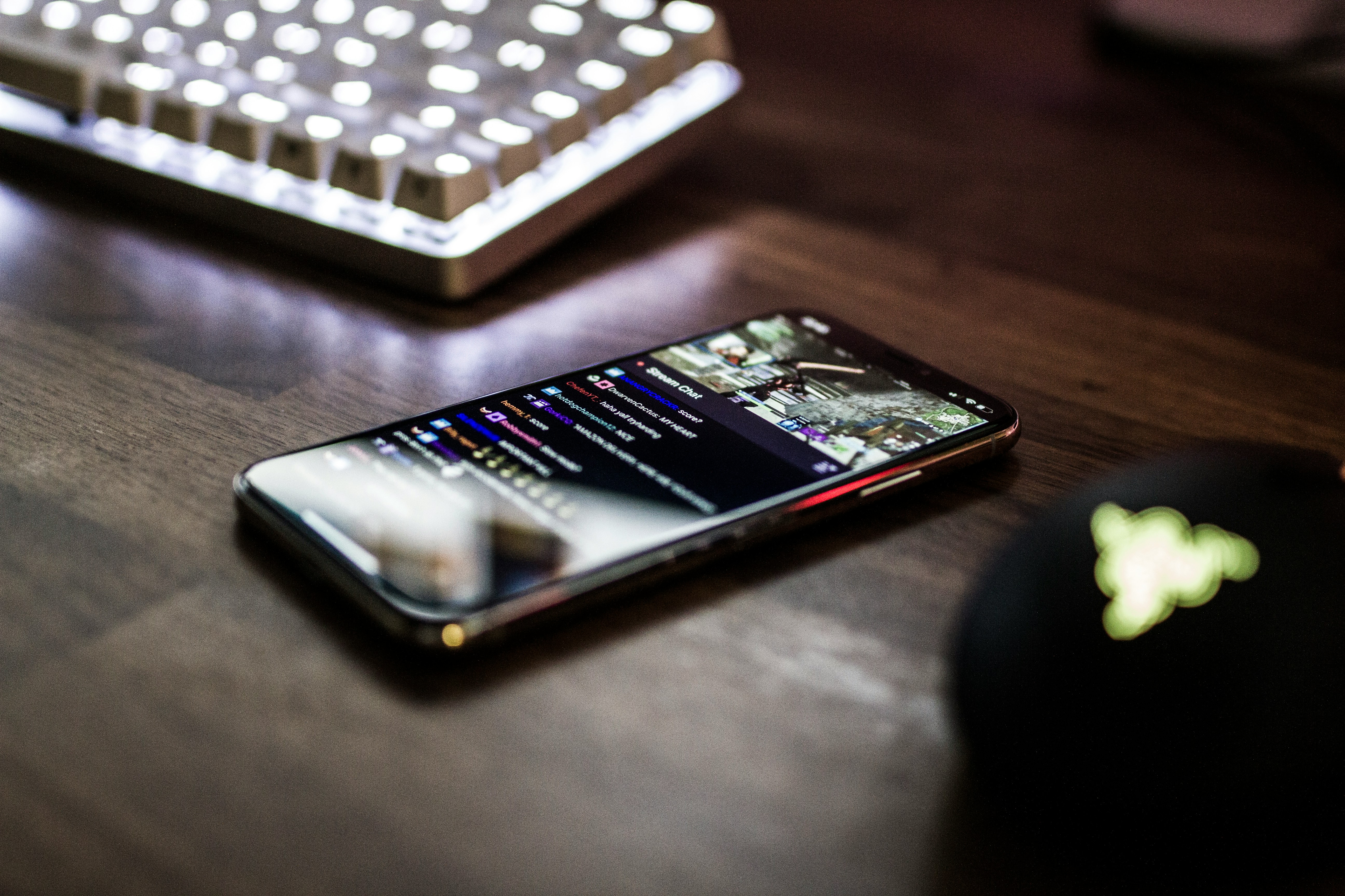 closeup photo of turned on smartphone near keyboard