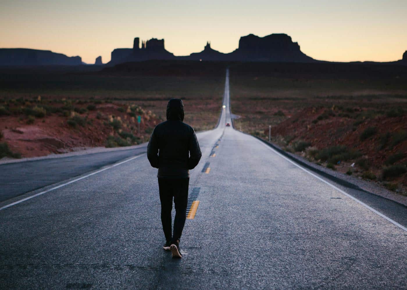 Man walking down an empty road