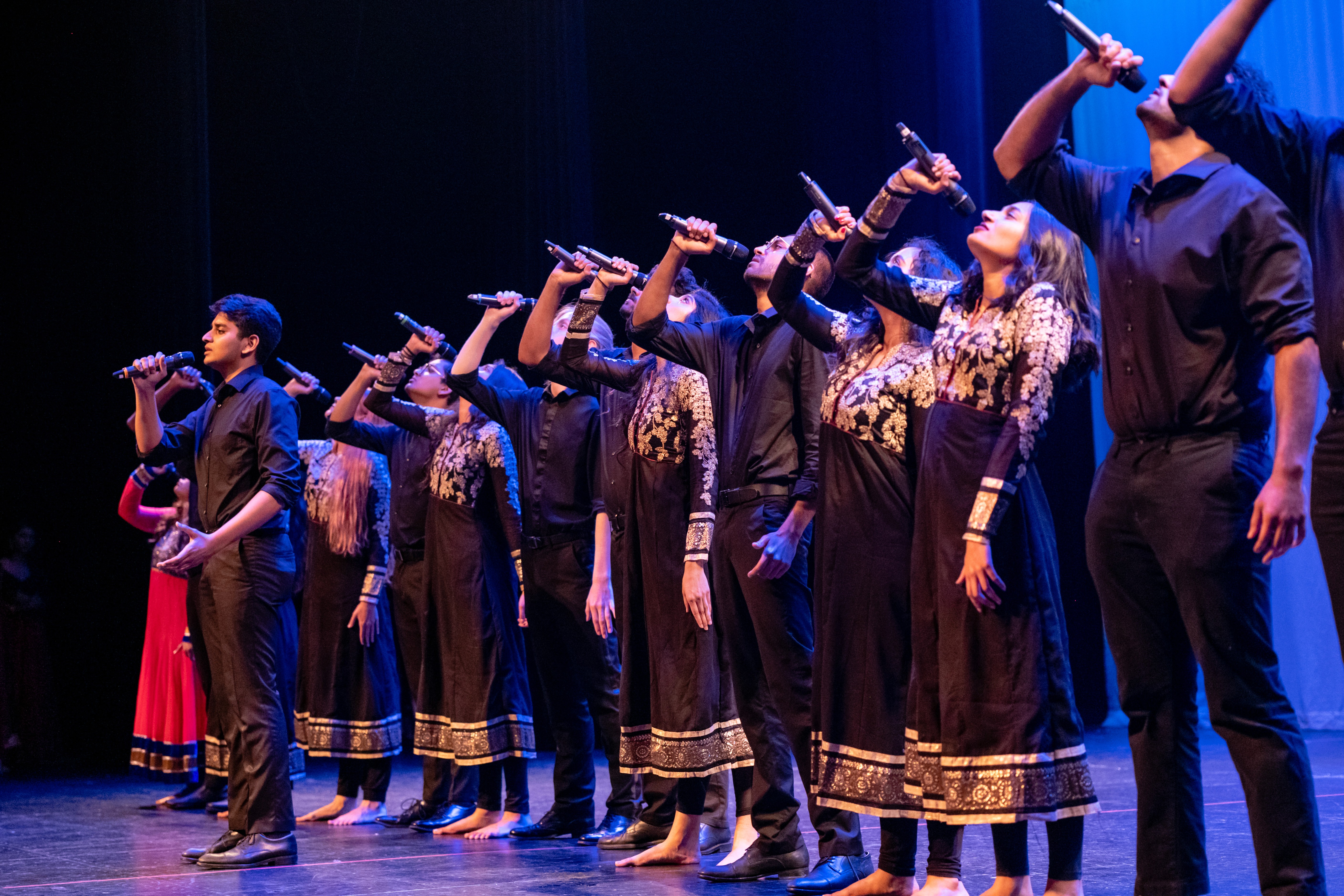 A team singing in a line formation with soloist at front