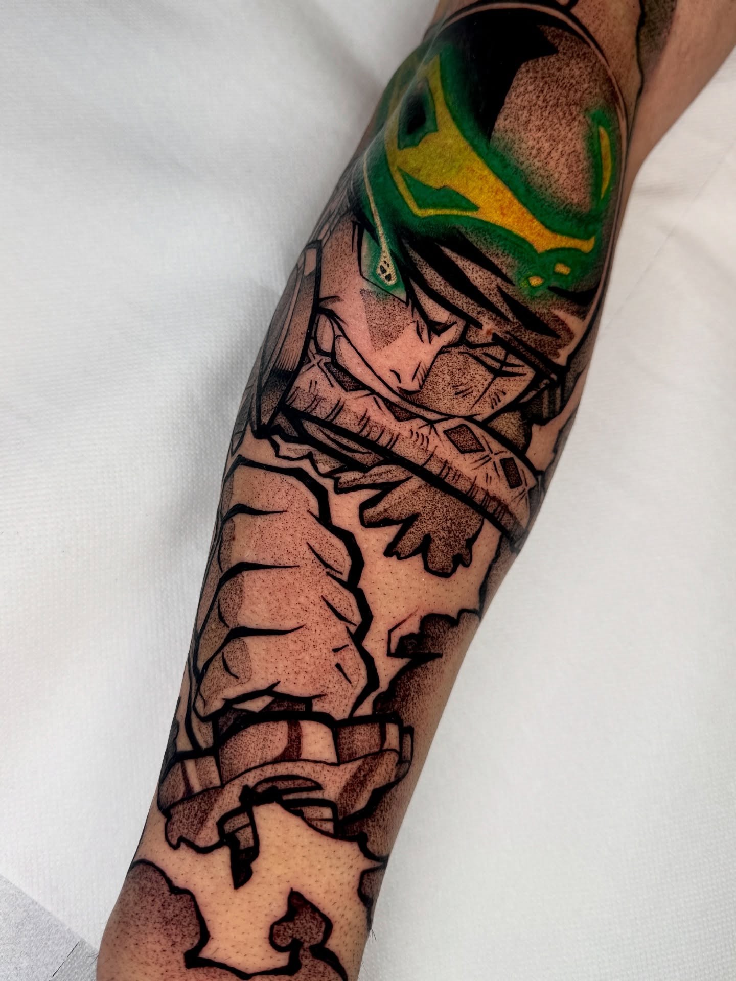 A forearm tattoo of Nezuko Kamado from Demon Slayer, depicted in a stylized anime art style. She is holding a sword.