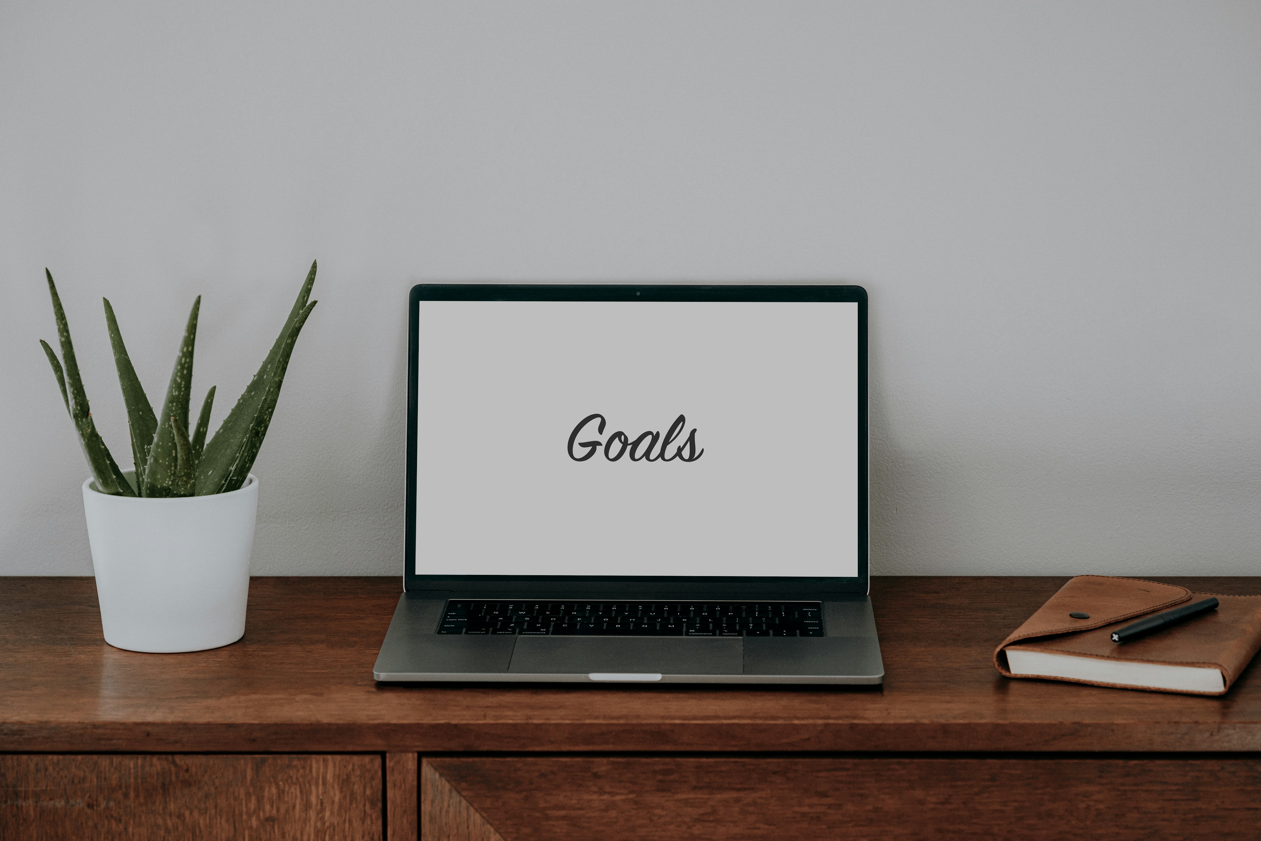 Laptop with "goals" placed on cupboard