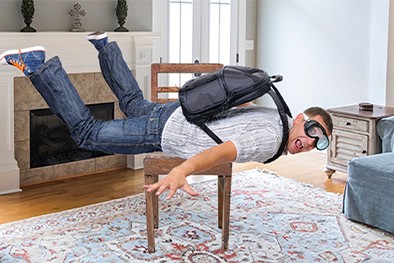 Close-up of lush, dark green leaves, some glossy and wet, against a muted background.