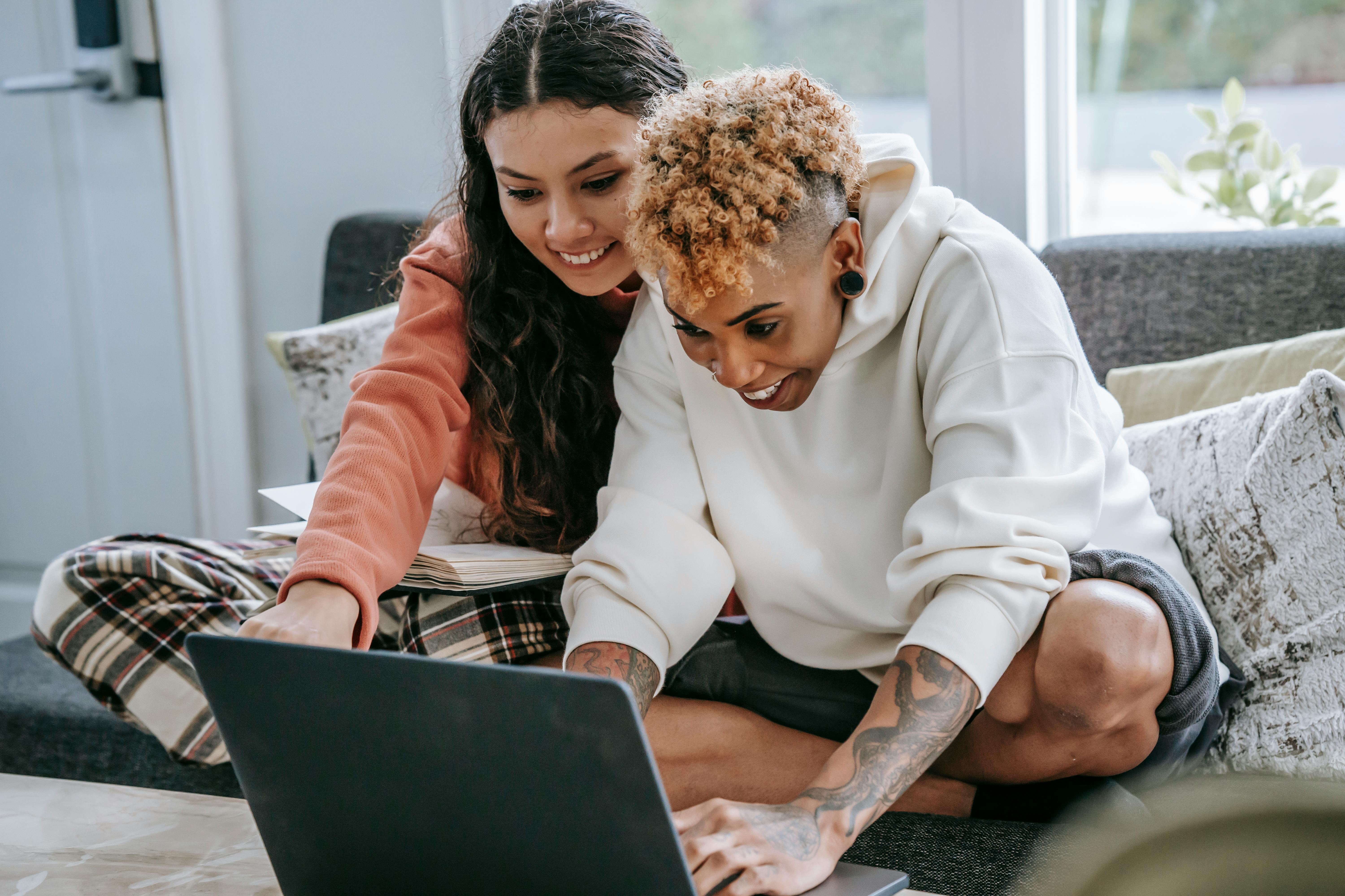 Two women looking at a laptop