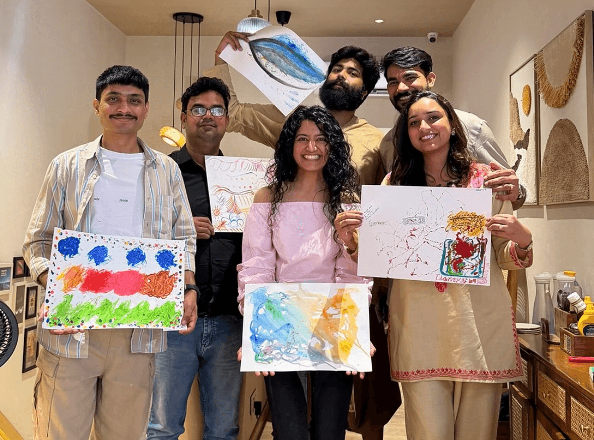 Group of people holding artwork.