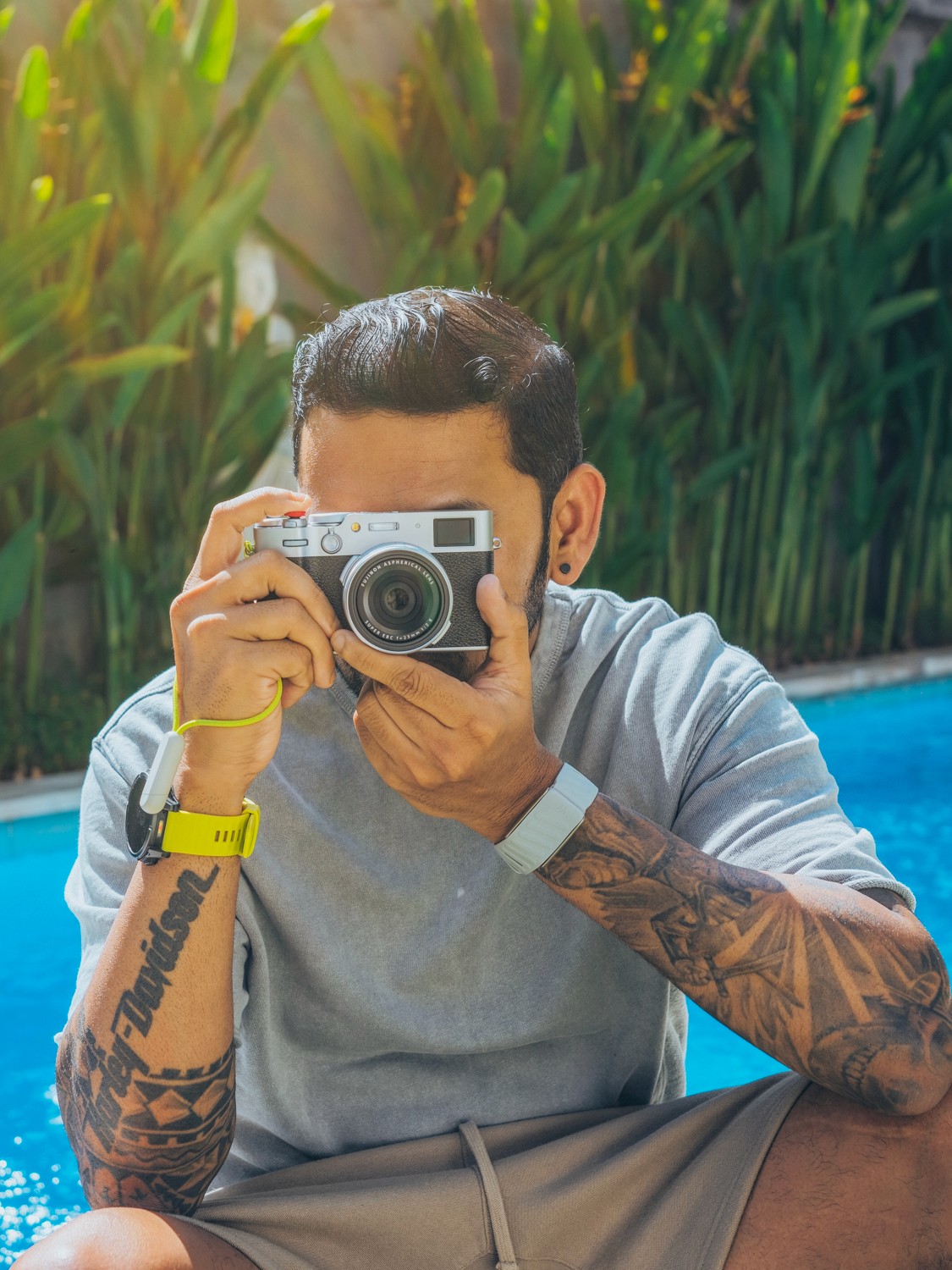 Side profile of a person wearing a red cap and yellow glasses against a red background.