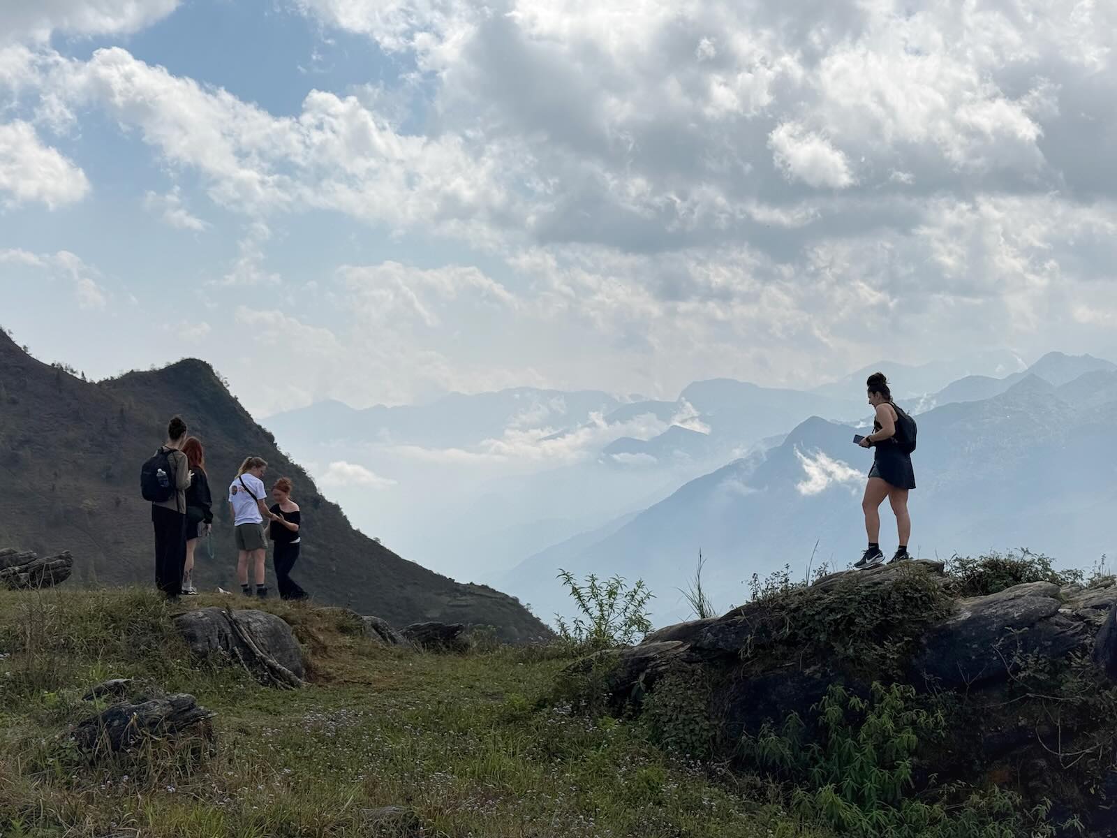Hikers overlooking mountain valleys during a trek in Sapa Vietnam