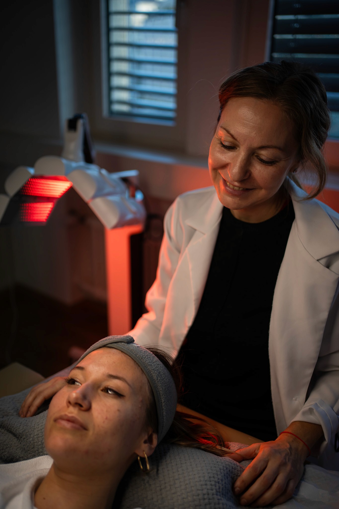 Cosmetologist performing a facial treatment on a client in a spa clinic