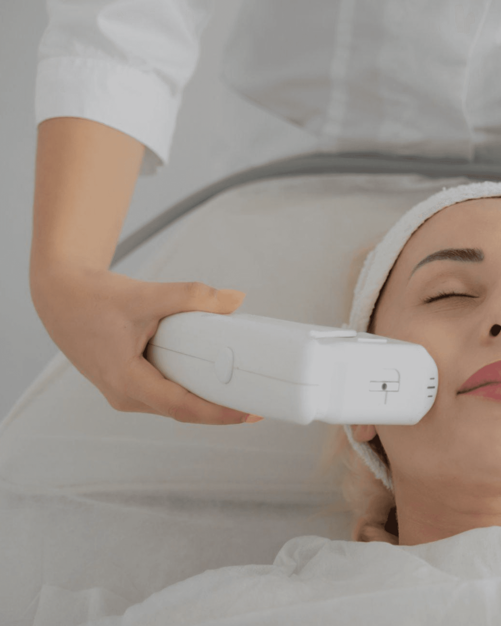 Patient receiving HIFU body treatment to tighten skin and stimulate collagen for non-invasive contouring of abdomen and thighs.