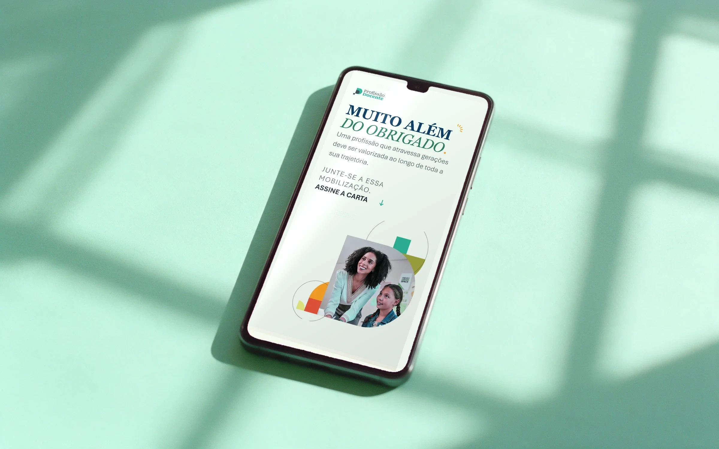 Landing Muito além do obrigado, da Profissão Docente, num celular sobre papel verde-menta