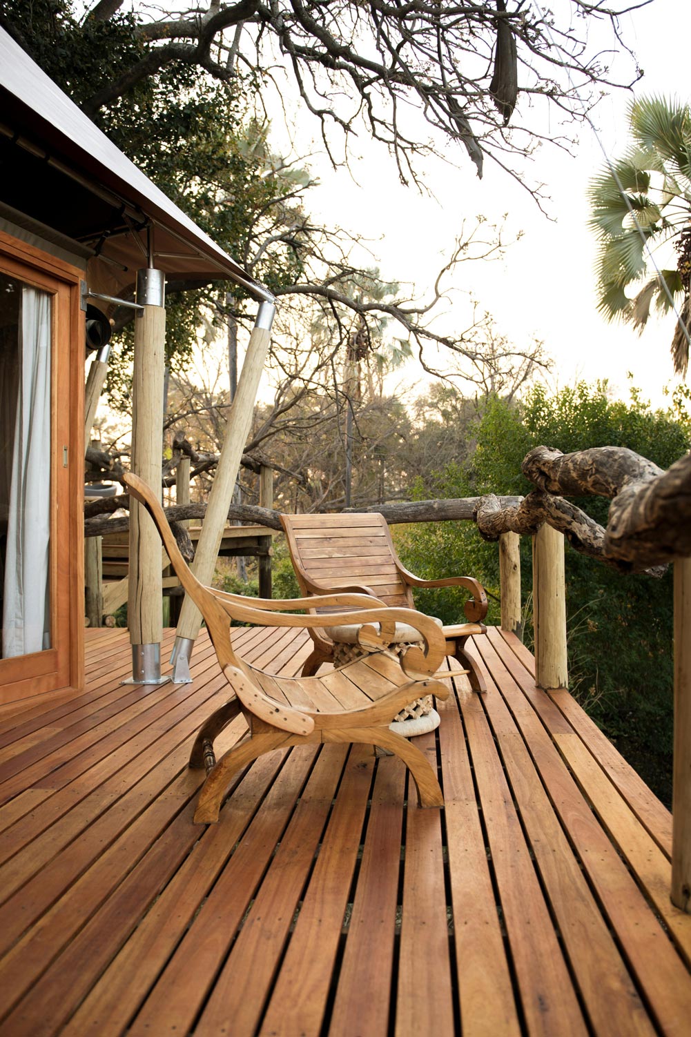 A long, wet walkway next to a wooden building.