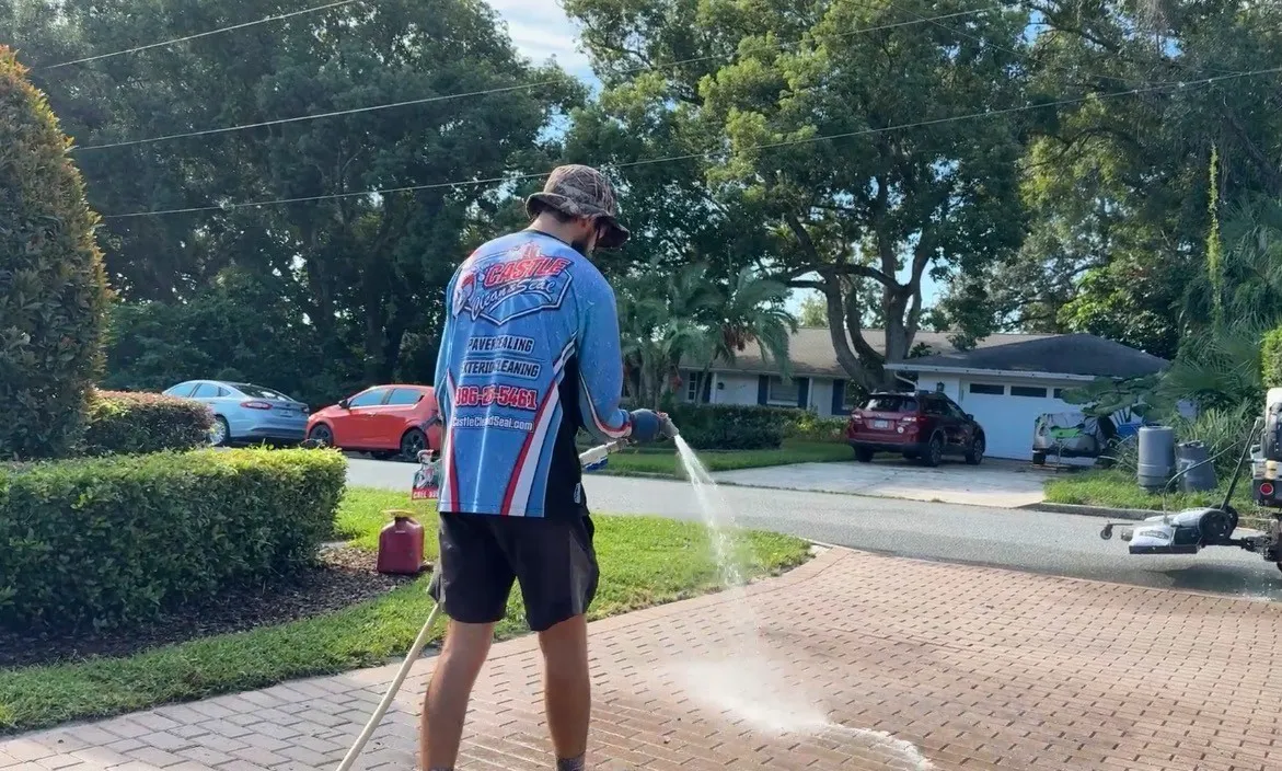 Technician sealing pavers