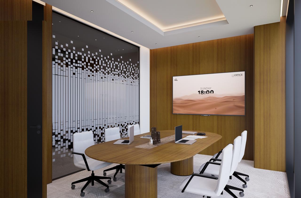 Enclosed meeting room with sound-dampening glass walls, round wooden table, and clean minimalist design.