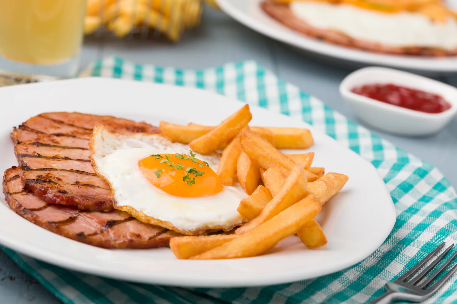 Thick, smoky bacon chop chargrilled and topped with a fried egg — simple pub comfort.
