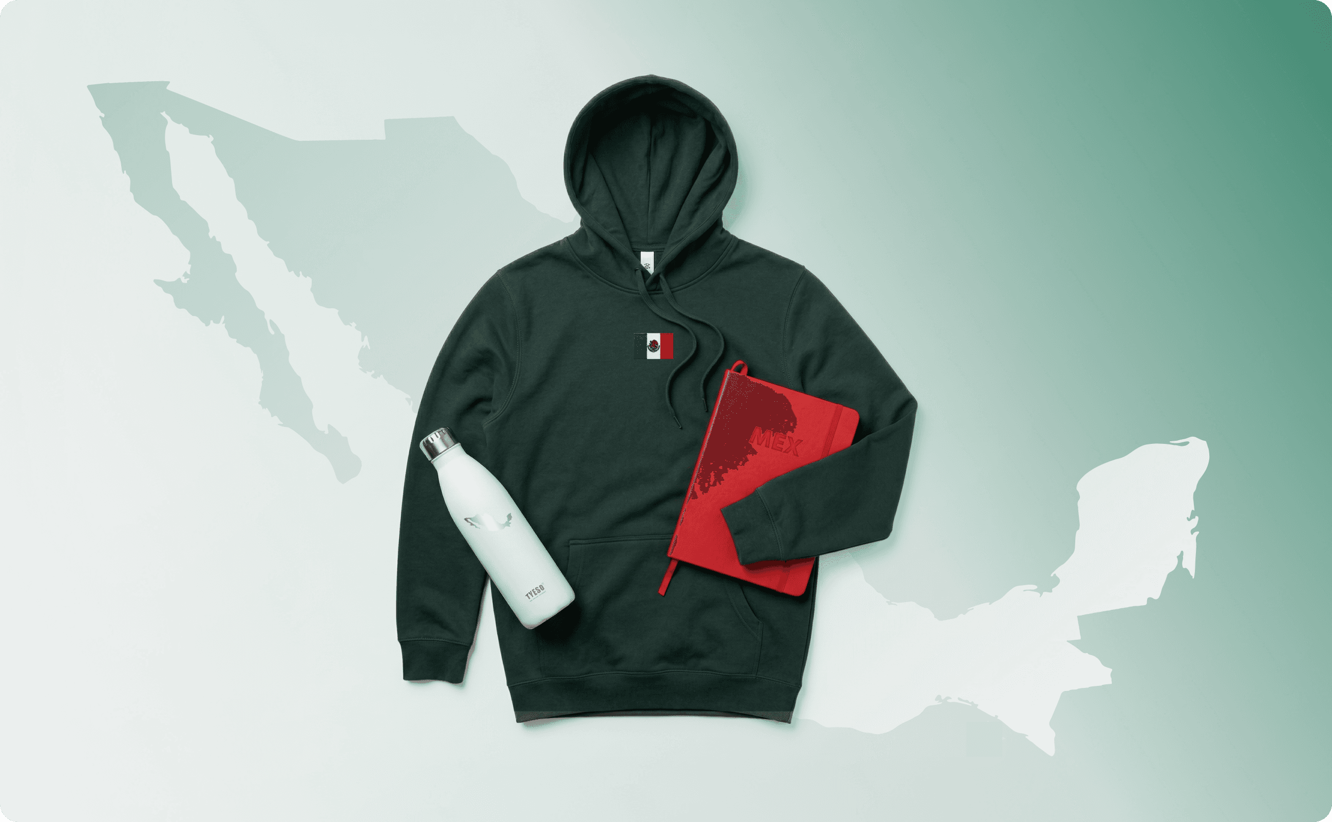 A map of Mexico, with a green hoodie, a water bottle, and notebook atop of it.