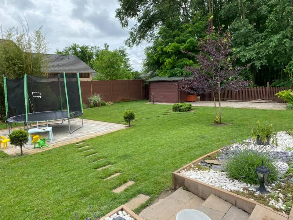 A lush garden path beside a home