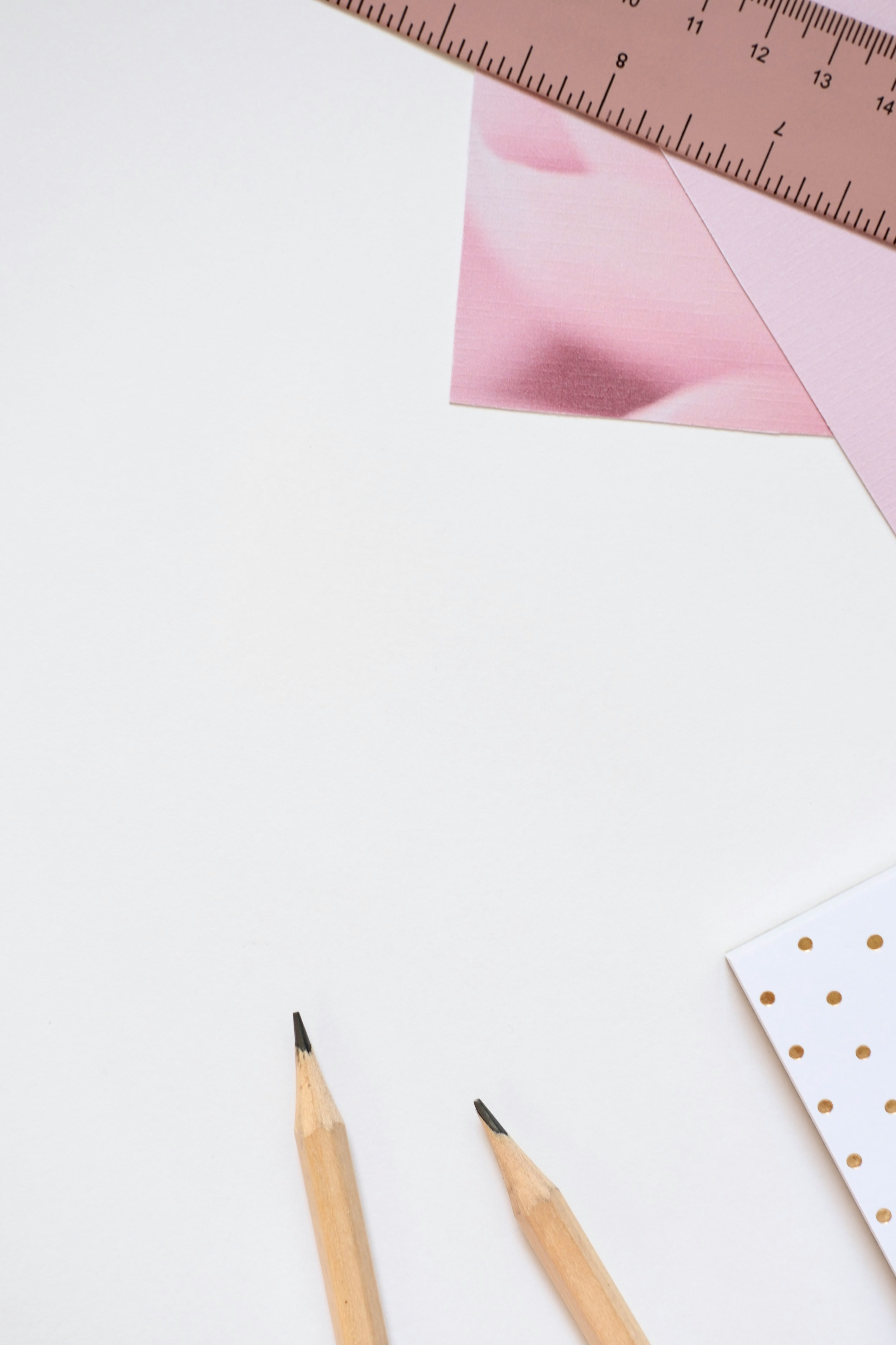 Two pencils and ruler on white background