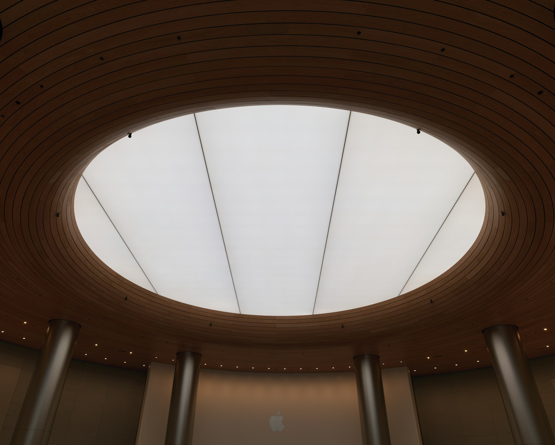 A circular ceiling in a building with a skylight