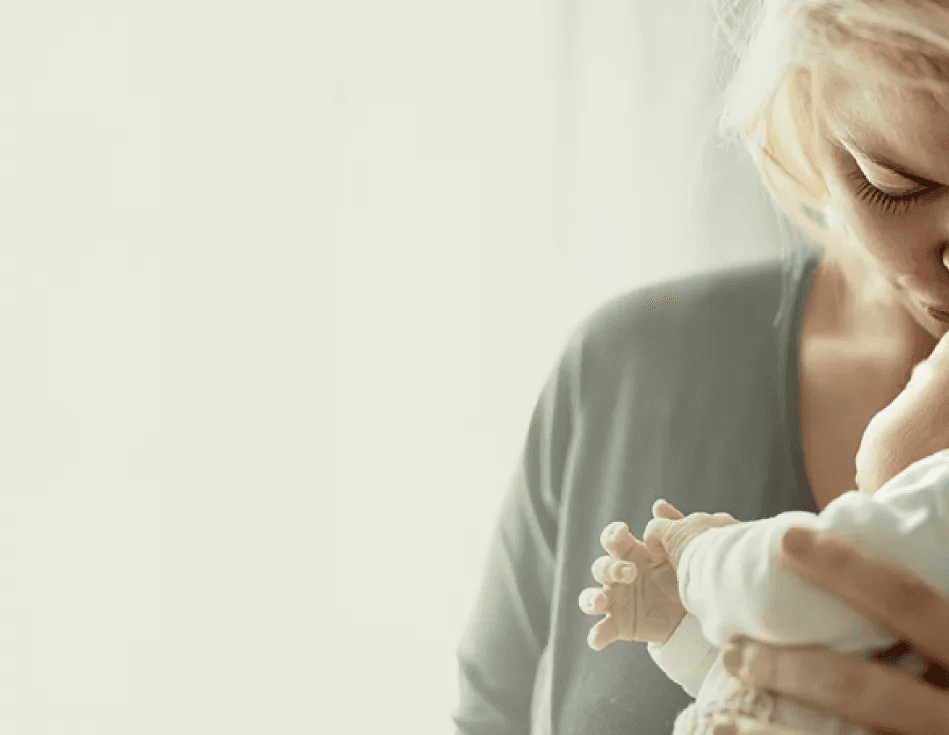Woman with her baby representing the postpartum care path