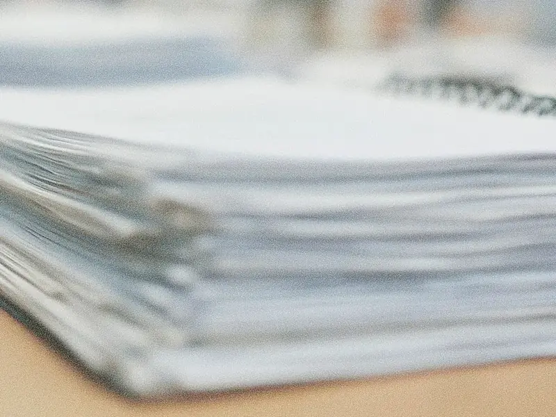 A consultant’s binder of paper on a boardroom table
