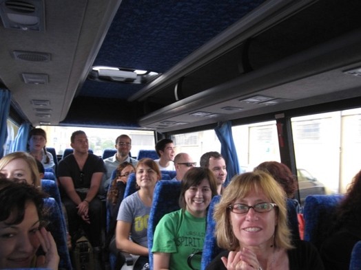 A photo of a group of people taking a ride in a bus.