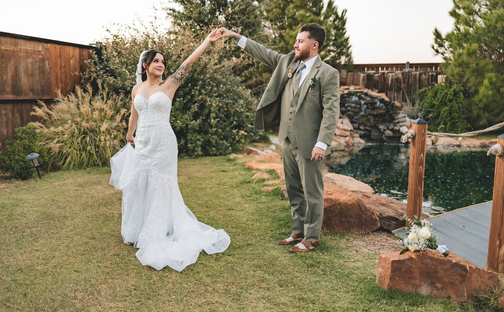 A couple in formal wedding attire embraces intimately in a vast.