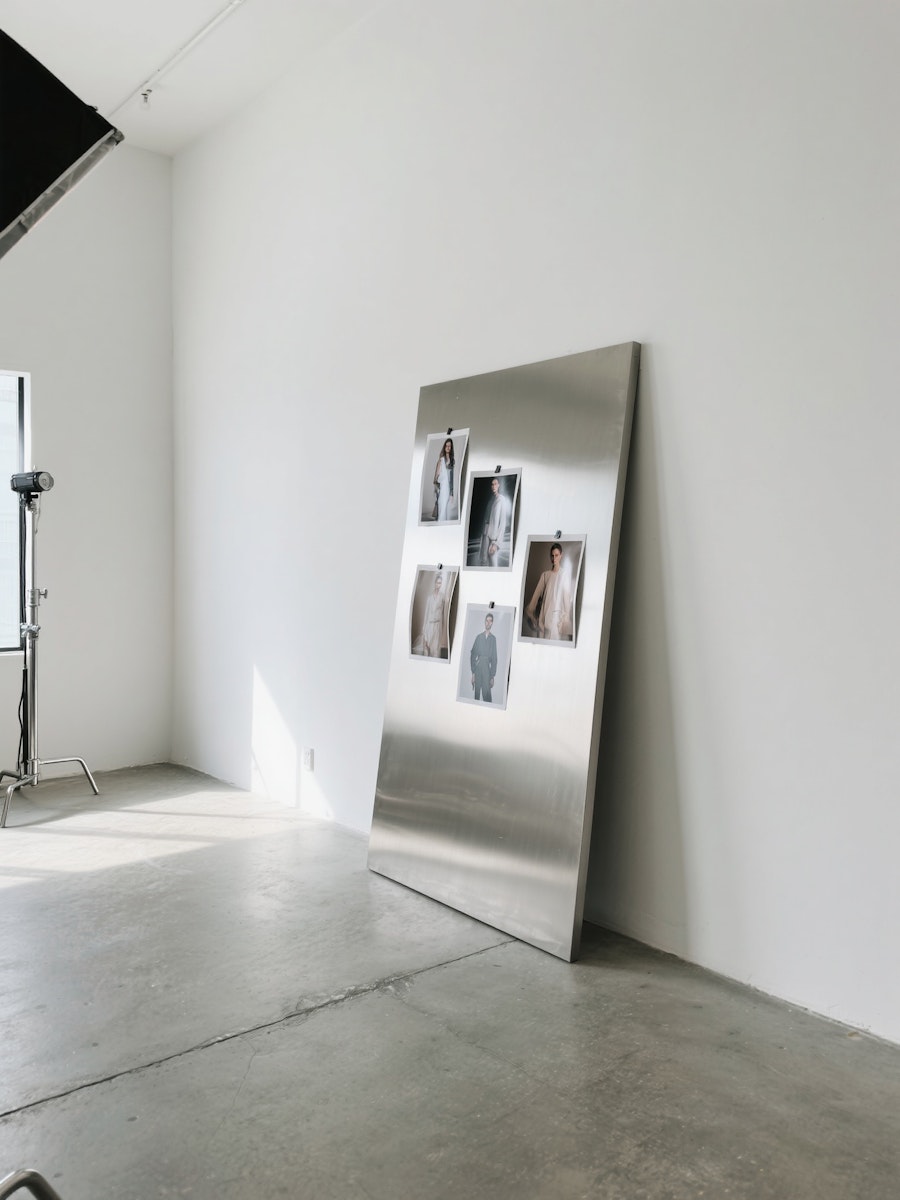 Office Studio with pictures on table lean on the wall.