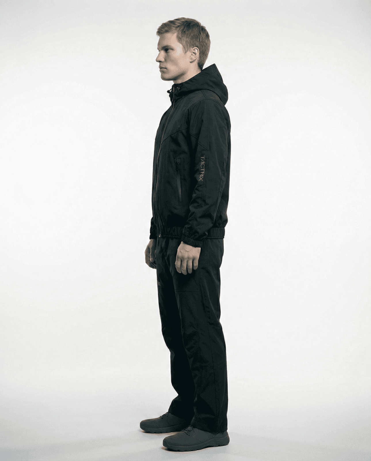 Model wearing black Tactrix tracksuit side profile